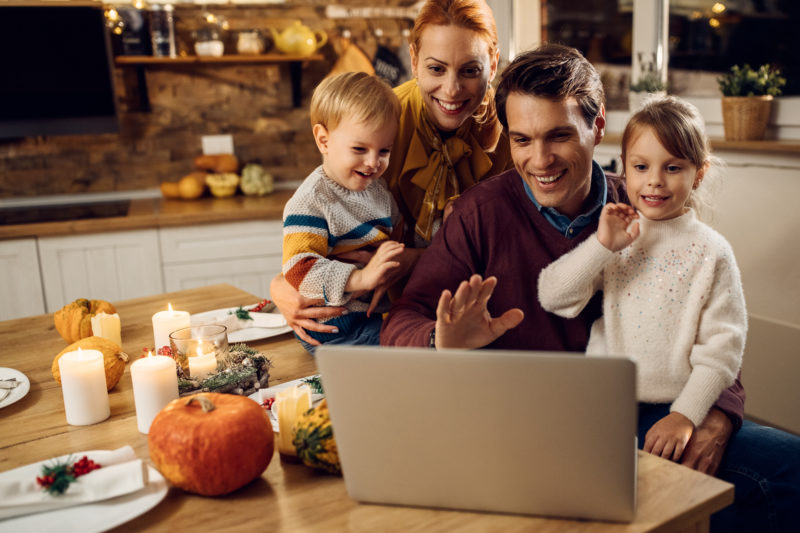 stock photo of family smiling at laptop